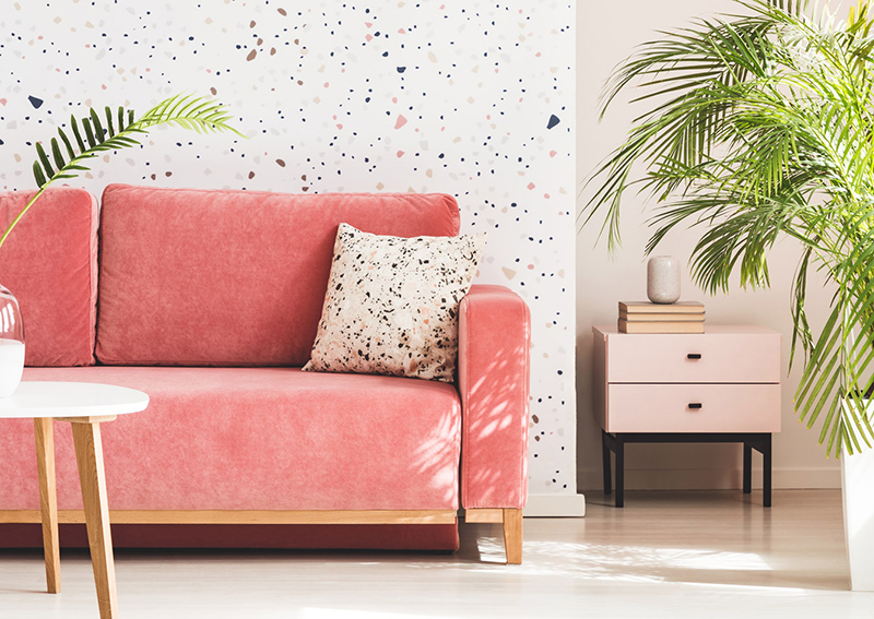 Coral couch in brightly lit apartment