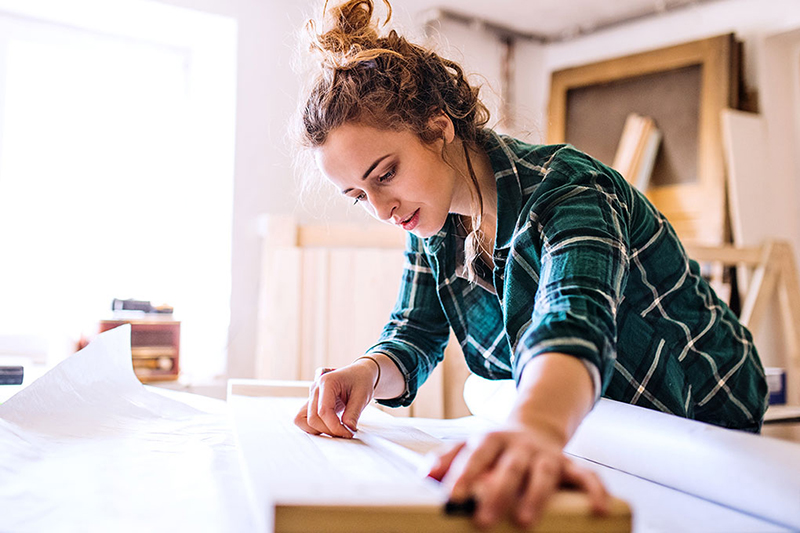 Young woman renovating her rental property